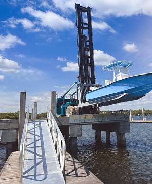 Boats are transferred to and from the water by a Marine Travelift machine.